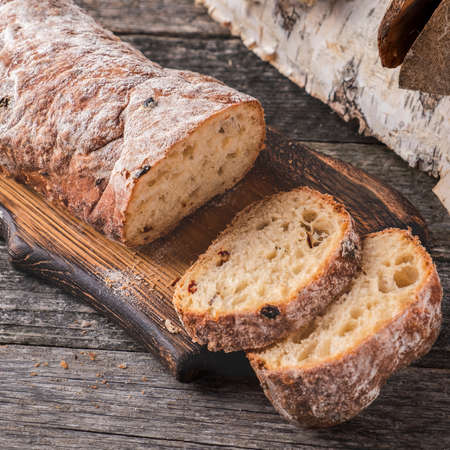 Ð¡iabatta bread on wooden cutting board.の写真素材