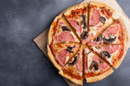 Tasty pizza with ham, mushrooms and cheese with copy space. Top viewの写真素材