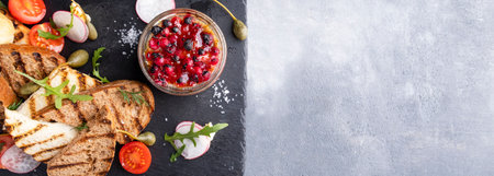 Duck pate with cranberry sauce and crispy bread. Banner. Text space, top viewの写真素材