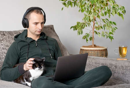 Young man working at home with laptop. Freelance work concept
