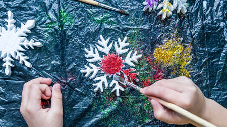 Child making Christmas snowflake. Christmas and New Year concept. Top viewの写真素材