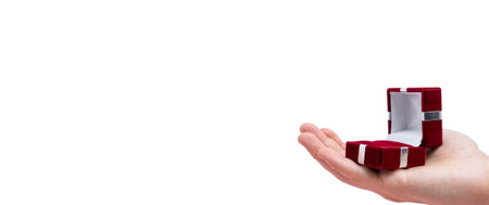 Man's hand holds opened red box isolated on white background. Wedding concept. Valentine's day. Text spaceの写真素材