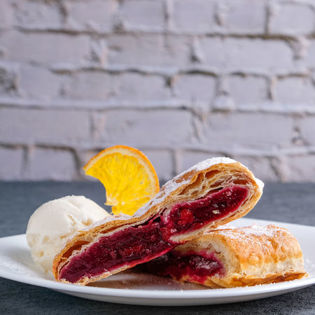 Sweet strudel with cherry and ice cream. Text spaceの写真素材