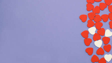 Valentines day symbol background. Red and white hearts on violet background. Copy space, top viewの写真素材