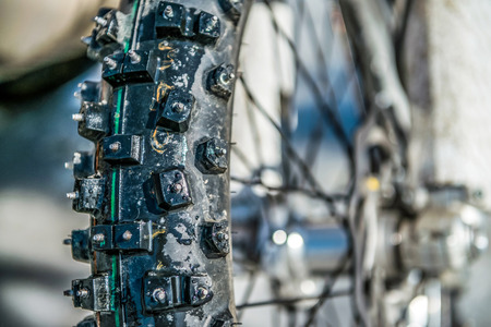 The wheel from a motorcycle with spikes in the winterの写真素材