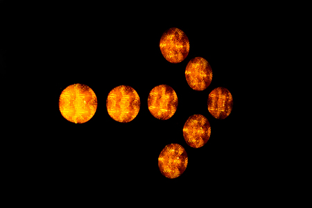 A glowing yellow arrow pointer on a black background