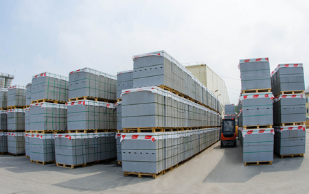 Forklift trucks in stock concrete blocks in outdoorの写真素材