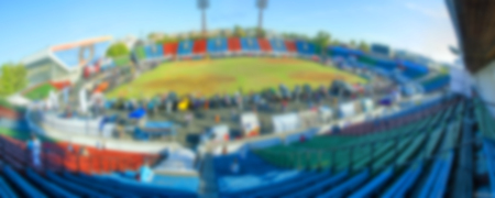 an open-air stadium, summer, green grass, blurredの写真素材