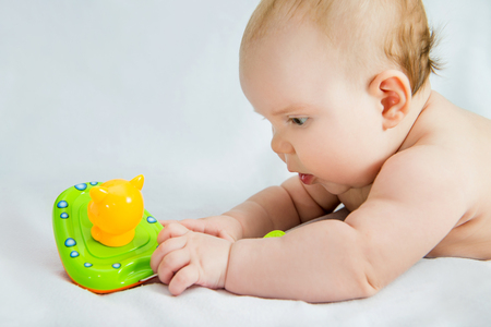the baby reaches for the toyの写真素材