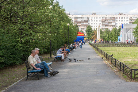 Chelyabinsk Russia July 25 2020 people relax in the Park on benches on a hot dayのeditorial素材