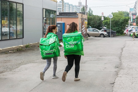 Chelyabinsk Russia July 26 2020 food delivery couriers carry orders to their customers