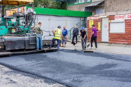Chelyabinsk Russia August 13 2020 workers asphalt the street with road equipmentのeditorial素材