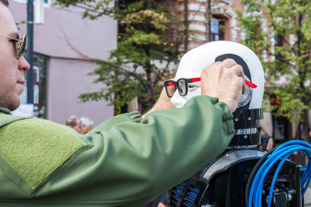Chelyabinsk Russia September 12 2020 A man puts glasses on a talking robot at a computer technology...