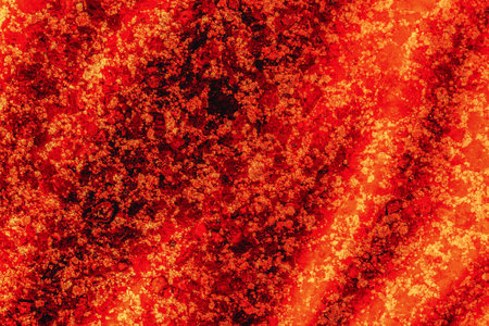 Abstract red background. Molten resin flows down the hot stone surface. The pattern and texture of...