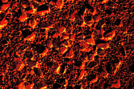 Burning coal in a red-hot village stove close-up. The pattern and texture of fire.