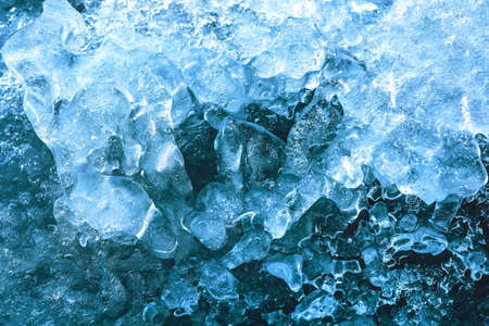 The pattern and texture of blue ice on a frozen river. natural ice background.