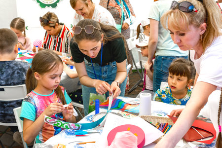 Chelyabinsk Russia June 25 2022: a master class on making paper decorative ornaments is being held at the children's holidayのeditorial素材
