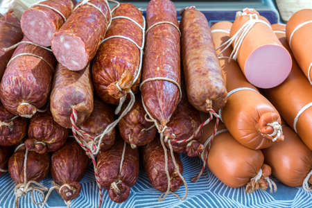 Artisan smoked and boiled sausage is sold at the grocery market. Meat food productsの写真素材