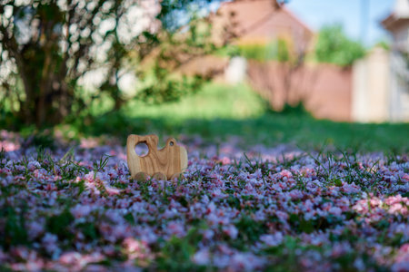 Natural wooden toy made of walnut wood on a green background. High quality photoの写真素材