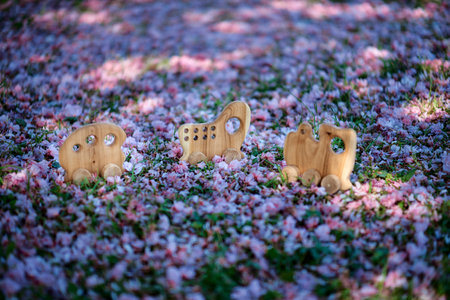 Natural wooden toy made of walnut wood on a green background. High quality photoの写真素材