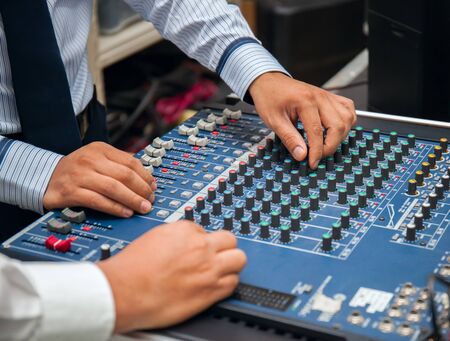 man hands tuning of sound mixer. stock photoの写真素材