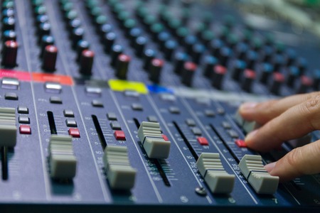 selective focus finger sound tuning of sound mixer close up. studiostock photo