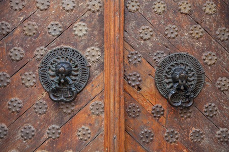 Twin antique handles old style on wooden doorsの写真素材