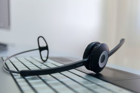 computer headphones on a keyboard of the notebook no manの写真素材