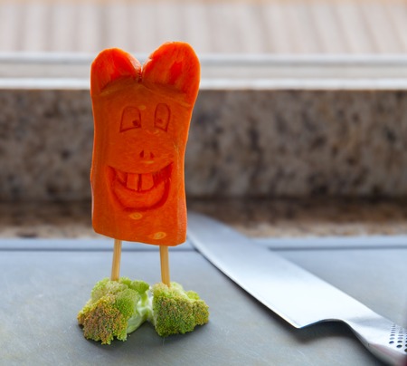 A rabbit made of carrot shod in slippers broccoliの写真素材