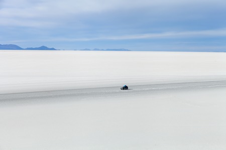 off-road vehicle driving on Salar de Uyuniの写真素材