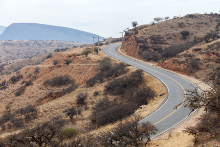 A winding mountain road running through the arid terrain of the Middle Eastの写真素材