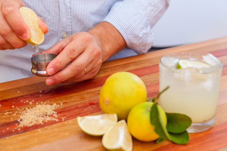 The bartender make margaritas of Mexican lime. alcoholic cocktail served a measuring glassの写真素材