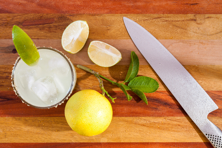 Key lime margarita garnished with fresh lime in a glass bar table knife. view from aboveの写真素材