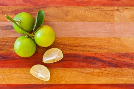 Key lime or Mexican lime on wooden table, one of main ingredient thai food and traditional pie. horizontalの写真素材