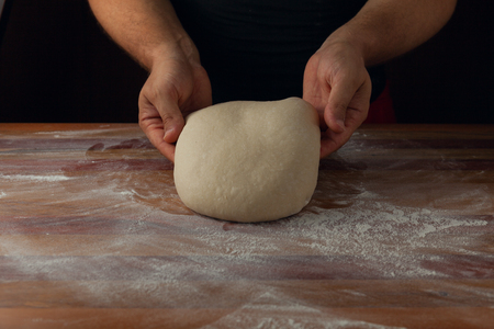Chief baker preparing dough for bread in a bakery. Kitchen professional. Stock photoの写真素材