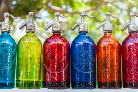 Antique Siphons bottles bright, colored Glass in Flea Market, Buenos Aires, Argentinaの写真素材
