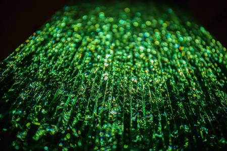 Green light passing through a stack of glass. Abstract background, bokehの写真素材