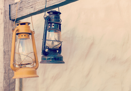 Kerosene lamp or lantern weighs on a wooden beam. horizontallyの写真素材