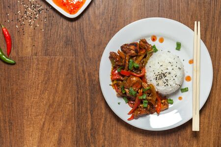 Sweet and Sour Chicken on Rice. Typical Asian dish. A lot of negative space for text. flat layout. Stock photoの写真素材