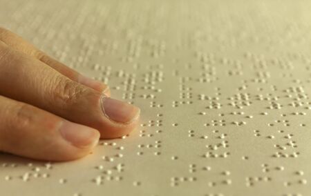 Braille reading. Blind woman reads a book in brailleの写真素材