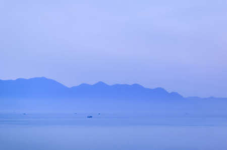 Ships in the harbor in the morning on the background of the misty mountainsの写真素材