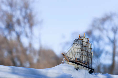 Model of a sailboat on a winter scene.