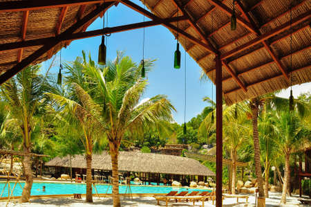 View of the pool in the park under the cane roof.の写真素材