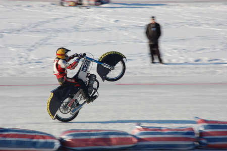 RUSSIA, BLAGOVESCHENSK - NOVEMBER 25, 2006: Speedway on ice. Motorcycle rear wheel stunt.のeditorial素材