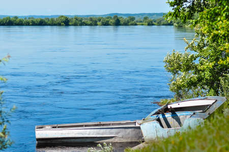 Two wooden boats on the river bank. Bureya river in the Amur region, Russia.の写真素材