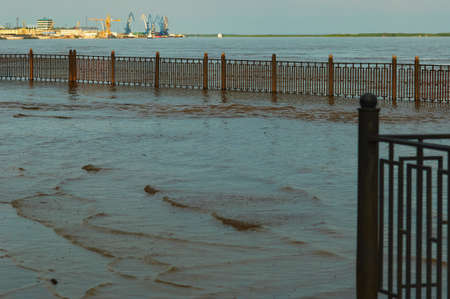 View from the flooded embankment to the cargo river port on the Amur River in Blagoveshchensk, Russia.の写真素材