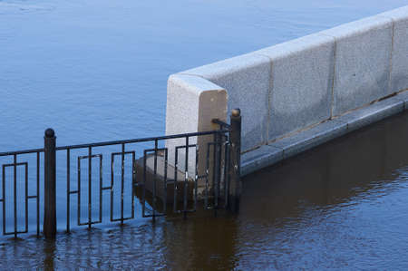 The lower level of the embankment during seasonal flooding. Early summer morning. Reflections and...