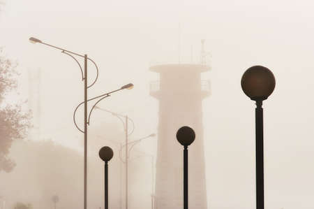 The lighthouse on the embankment of the city of Blagoveshchensk in a strong dense fog. Strong...