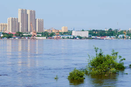 View of the Heihe river port during the flood. Flooded treetops. View of China from the city of Blagoveshchensk, Russia.の写真素材
