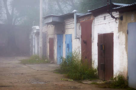 Thick fog on the city embankment. Silhouettes of lanterns and fence. A rare natural phenomenon. Blagoveshchensk, Russia.の写真素材